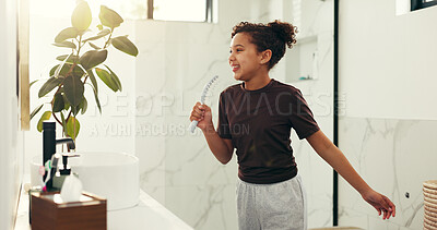 Buy stock photo Girl, child and singing with brush in bathroom for hair care, getting ready performance and energy. Happy, kid and karaoke in home for beauty routine, morning fun and dancing with positive attitude