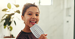 Hairbrush, smile and child singing in bathroom for morning routine, performance and good mood. Happy girl, kid and karaoke with hair tool, space and playful face with portrait for music in home
