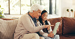 Home, tablet and grandmother with girl, help and bonding together with ebook, support and granny. Learning, talking and family with senior woman, kid and development with tech or app for online game