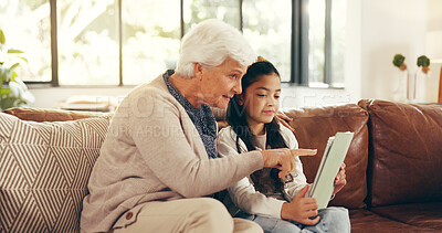 Buy stock photo Home, tablet and grandmother with girl, help and bonding together with ebook, support and granny. Learning, talking and family with senior woman, kid and development with tech or app for online game