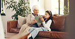 Home, tablet and grandmother with girl, conversation and bonding together with elearning. Discussion, granny and family on couch, old woman and child development with tech and digital app for ebook