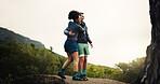 Smile, couple and hiking with hug on mountain for view, travel adventure and bonding on holiday. Happy, people and embrace on rock for sightseeing, trekking trip and backpacking vacation in nature