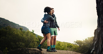 Buy stock photo Smile, couple and hiking with hug on mountain for view, travel adventure and bonding on holiday. Happy, people and embrace on rock for sightseeing, trekking trip and backpacking vacation in nature