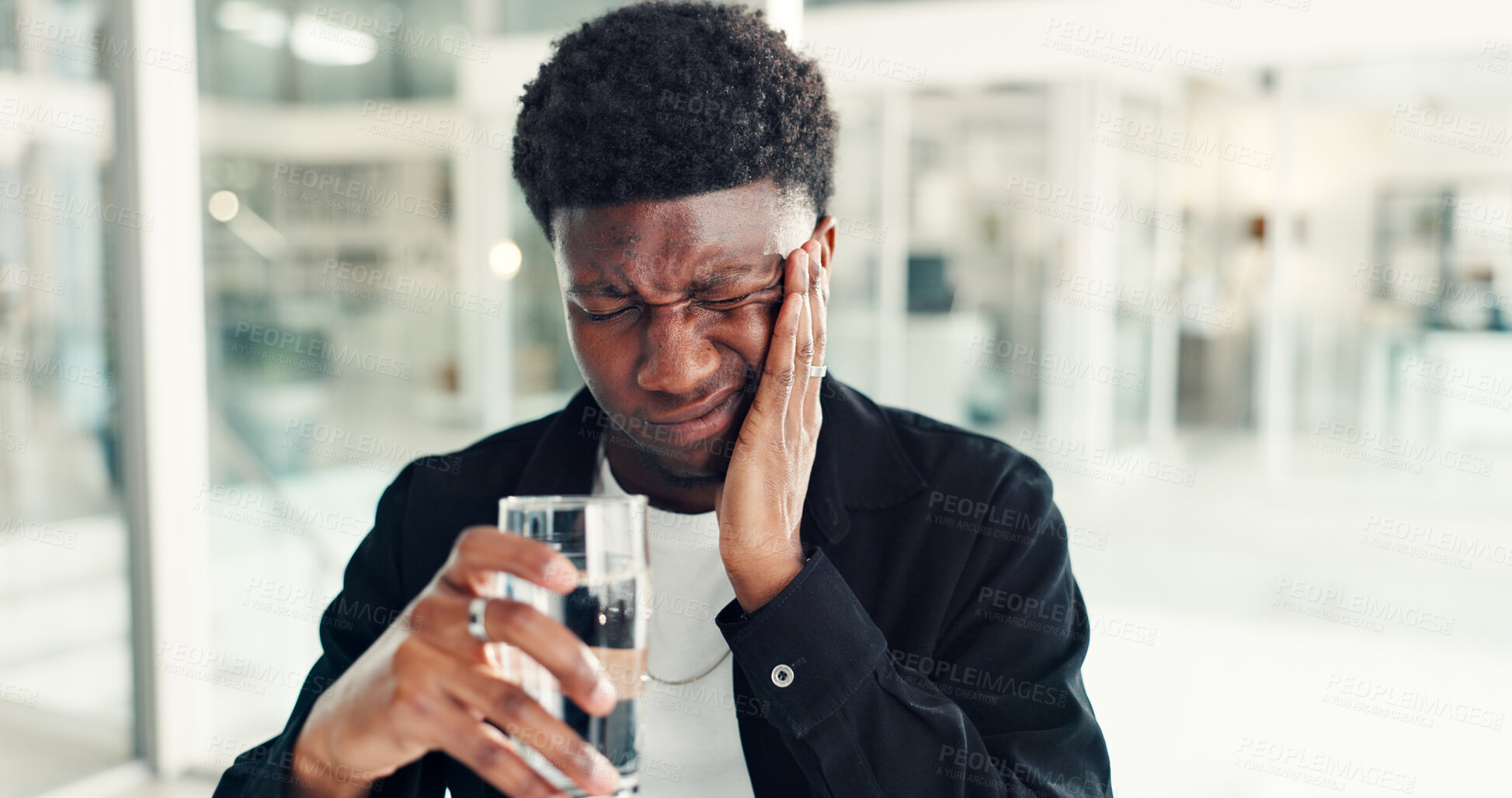 Buy stock photo Black man, toothache and water in office with pain, sensitive gums or gingivitis with cavity at work. Professional male person, glass or beverage with dental problem, nerve issue or hurt in workplace
