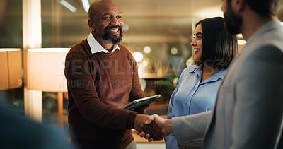 Buy stock photo Handshake, meeting and smile with business people in office at night for feedback success. Tablet, shaking hands and agreement with employee team for work goals, collaboration or partnership strategy