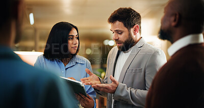 Buy stock photo Night, discussion and team of business people in office with tablet, feedback and article ideas or meeting. Creative, media agency and men with woman for brainstorming, news story and planning report