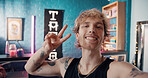 Selfie, peace sign and tattoo artist or man in store for social media, online promotion and body art parlor. Small business, creative culture and ink aesthetic with person in shop for design