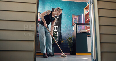 Buy stock photo Cleaning, broom and small business with man in tattoo parlor for preparation or start of work. Hygiene, maintenance and sweeping with person in startup studio for chores, responsibility or tasks
