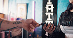 Hands, people and credit card for payment at shop, tattoo parlor and banking with finance debit. Small business owner, customer or client paying with fintech, pos machine and transaction at studio