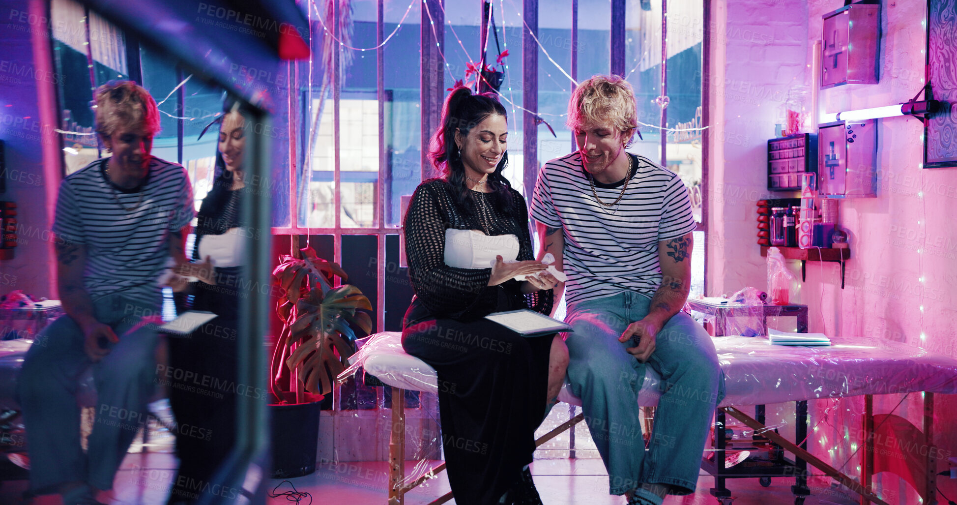 Buy stock photo Tablet, tattoo artist and stencil with client in studio for artwork design preview, aesthetic or body art culture. Permanent ink decision, customer and creative process with people for digital sketch