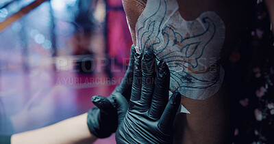 Buy stock photo Tattoo artist, stencil and hands with person in store for body art design, neon studio or culture. Permit ink aesthetic, customer and artwork with people in parlour for creative, process and identity