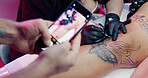 Photography, phone screen or people at parlor with tattoo, aesthetic or ink culture for social media. Artist, leg design or creative at studio with mobile, art or website update for small business.