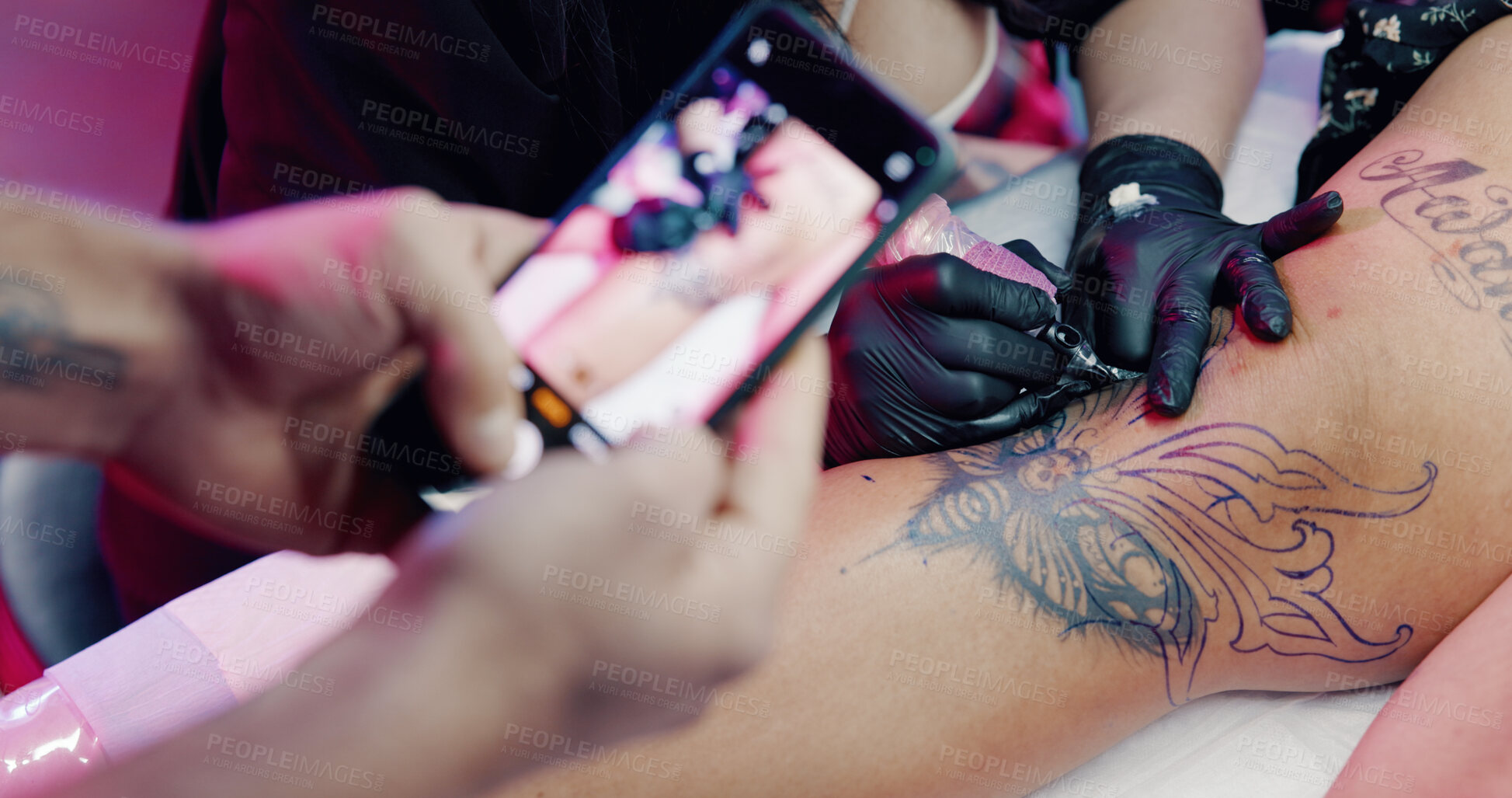 Buy stock photo Photography, hands or people at parlor with tattoo, aesthetic or ink culture for social media. Artist, leg design or creative at studio with smartphone, art or website update for small business.