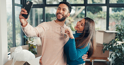 Buy stock photo Happy couple, selfie and new house keys for hug, excited or memory with web post, boxes and moving. Man, woman and embrace for photography, care or social media for real estate investment at property