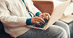 Hands, laptop and typing with person on sofa in living room of home for remote work or research. Computer, planning and report with freelance employee in apartment for email communication or feedback