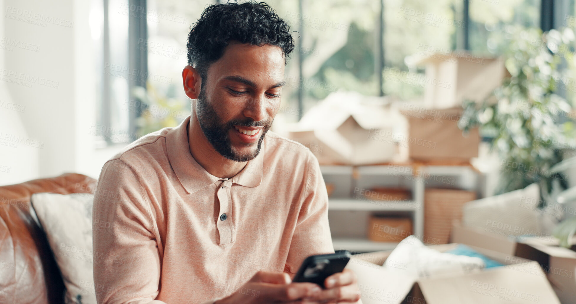Buy stock photo Happy, social media and man in home with phone, doom scrolling and funny chat on app. Digital, meme and Asian male in living room with mobile, game or online communication in message update.