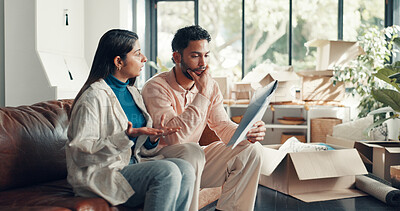 Buy stock photo Couple, documents and stress with moving at new home with talk, loan or mortgage for property investing. People, man and woman at house, contract and frustrated with financial crisis for real estate
