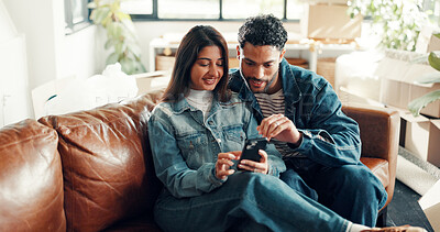 Buy stock photo Happy couple, reading and together on couch with phone, bonding and scrolling online for social media post. Smile, man and woman in home with mobile, connection and notifications on digital app.