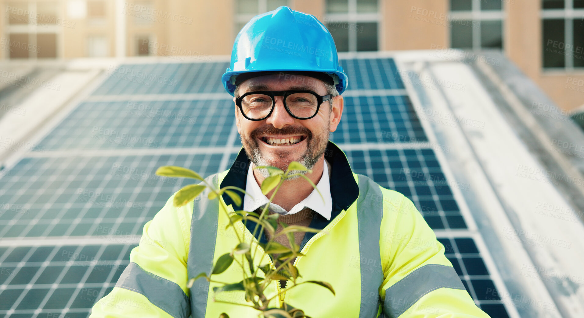 Buy stock photo Plant, portrait and solar energy with man on roof in city for conservation or sustainability. Building, photovoltaic power and smile of happy mature construction worker outdoor for panel installation