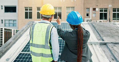 Buy stock photo Planning, pointing and solar energy with construction worker people on roof of building from back. Collaboration, engineering and vision with team outdoor for installation of photovoltaic panel