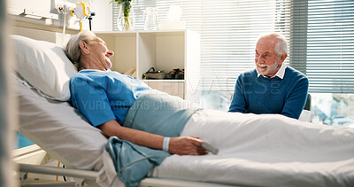 Buy stock photo Talking, visit and senior woman in hospital with husband for bonding, support or care in recovery. Medical appointment, marriage and elderly female patient in ward bed for consultation in clinic.