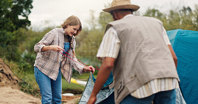 Buy stock photo Tent, help and couple with camping in nature for adventure, holiday or weekend trip together. Assistance, preparation and woman with man for setting up equipment for vacation outdoor with support.