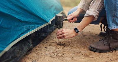Buy stock photo Hands, person and tools for pitching tent for camping adventure, setup preparation and holiday. Woman, hammer and assemble shelter of equipment security, survival skills and vacation safety in nature