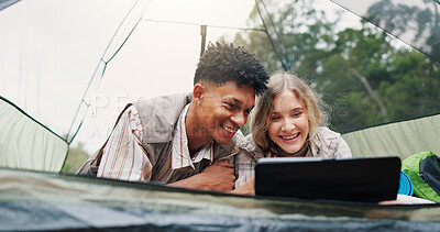 Buy stock photo Smile, couple and relax in tent with laptop for research, watching movies and bonding together. Happy, people and rest with pc on camping getaway, browsing internet and online entertainment in nature