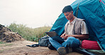 Typing, hiker and man with laptop, tent and travel writer on holiday, remote work or research on web. Online, author and person with tech for article, freelancer and vacation in forest and outdoor