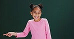 Studio, portrait and child with smile, pointing and happy for presentation, discount or mockup space. Green background, advertising and girl with positive attitude for offer alert, deal and news