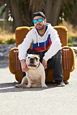 Buy stock photo Couch, city and portrait of man with dog in street for urban fashion, casual style and trendy outfit. sunglasses, pets and person on sofa in road with canine, bulldog and best friend for relaxing