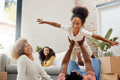 Buy stock photo Home, family and girl with airplane, game and relax with fun, happiness and bonding together in lounge. Apartment, new house and parents with children, smile and love with boxes, trust and expression
