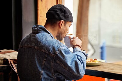 Buy stock photo Man, coffee shop and drinking at morning with breakfast in a restaurant with hot cappuccino. Cafe, brunch and table with hungry traveler with tea by the window of a bistro with food and latte