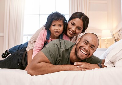 Buy stock photo Shot of a young family relaxing at home