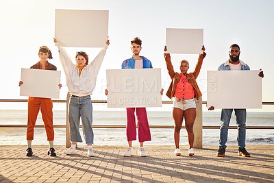 Buy stock photo Portrait, poster and diversity with friends together holding signage in protest on the promenade by the sea. Freedom, mockup and billboard with a man and woman friend group holding blank sign boards