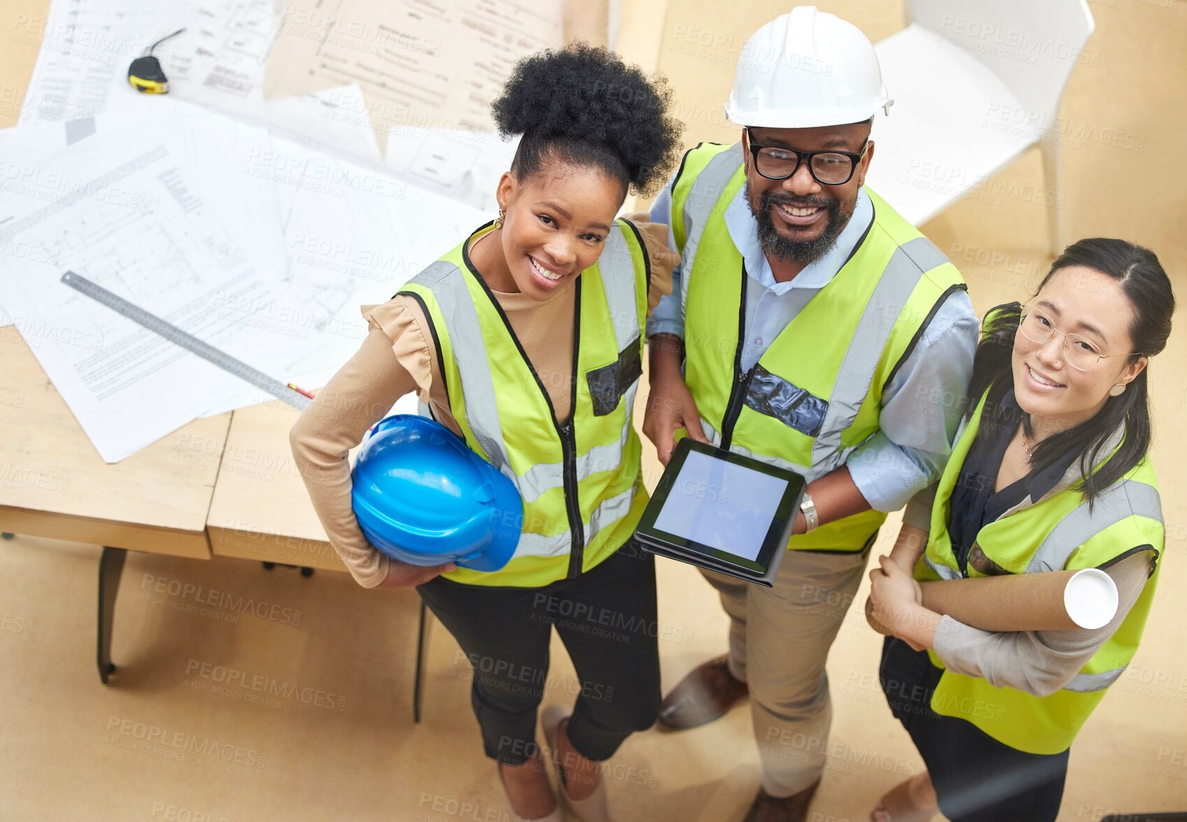 Buy stock photo Tablet, teamwork or portrait of engineers with designer planning a construction for architecture. Top view, blueprint or happy black people with Asian woman meeting together on a development project
