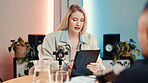 Woman, tablet and mic for interview in studio with guest, audio broadcast and live streaming chat. Presenter, digital and question celebrity in talk show, online platform and script for media podcast