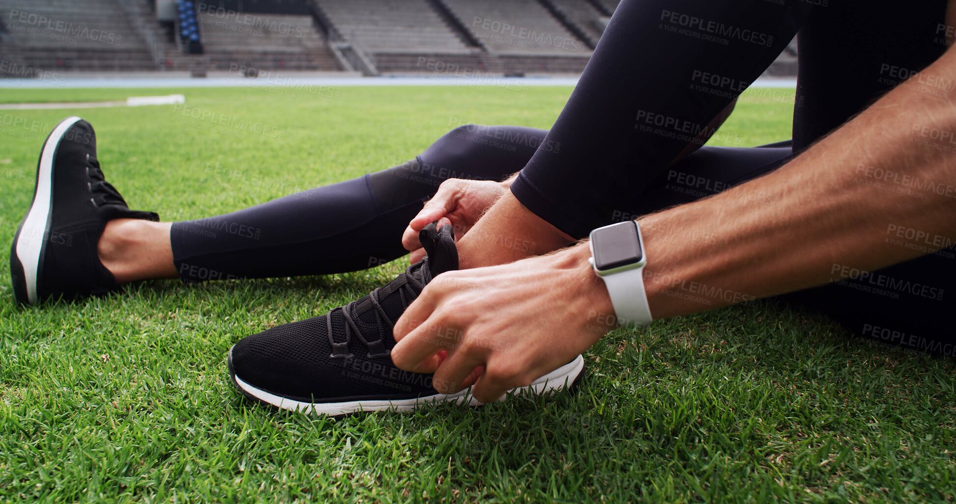 Buy stock photo Hands, shoes and tie with person on field in stadium for start of cardio training, fitness or workout. Exercise, laces and sneakers with runner getting ready for competition or sports in arena