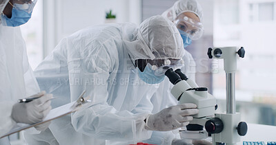 Buy stock photo Scientist, team and microscope with PPE, discussion and clipboard for medical research or study. People, teamwork and data analysis with test results, biotechnology and protective suit for healthcare