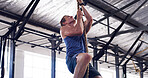 Athlete, man and climbing with rope for fitness, exercise and training for body strength. Male person, equipment and intense workout for weightlifting, muscle endurance and power challenge in gym
