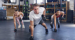 People, coach and fitness with dumbbells in gym for muscle gain, workout or exercise. Active, personal trainer or training with group in class for balance, strength or weightlifting in health club