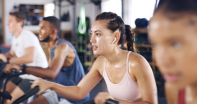 Buy stock photo Spin class, cycling and earphones with woman in gym for intense workout, music and cardio challenge. Fitness, streaming and stationary bike machine with people in sports club for health and energy