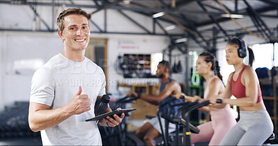 Buy stock photo Thumbs up, fitness and portrait of personal trainer with group in gym for cycling workout. Happy, tablet and male coach with spinning class for exercise, wellness or training in sports center.