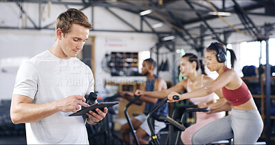 Buy stock photo Man, instructor and tablet with people in spin class for fitness results, schedule session and progress. Coach, digital app and track for cycling exercise, training performance and workout management