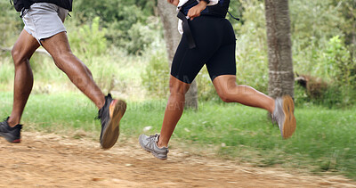 Buy stock photo Fitness, legs and couple running in forest for health, wellness or training outdoor. Man, woman and shoes of trail runner in woods for cardio workout, endurance exercise and practice in nature