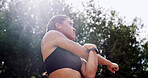 Woman, warm up and stretching in park for fitness, arms preparation and thinking for wellness. Nature, outdoor and training for exercise with runner, getting ready and flexibility with low angle