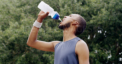 Buy stock photo Fitness, man and water in nature for health, wellness or exercise break with hydration liquid. Bottle, person and thirsty runner with drink outdoor for workout recovery, minerals and sports nutrition