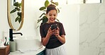 Cellphone, happy and child in bathroom in home with social media, networking or communication. Smile, technology and girl kid with phone for contact or online scroll on mobile app in morning at house