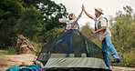 Couple, camping and high five by tent, happy and excited for achievement, goals or holiday in nature. People, man and woman in woods with interracial love, celebration and pitch shelter for glamping