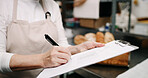 Baker, hands and writing on document in kitchen for supplies, stock or order. Pastry chef, clipboard and woman in bakery for inventory notes, checklist and schedule with signature in business